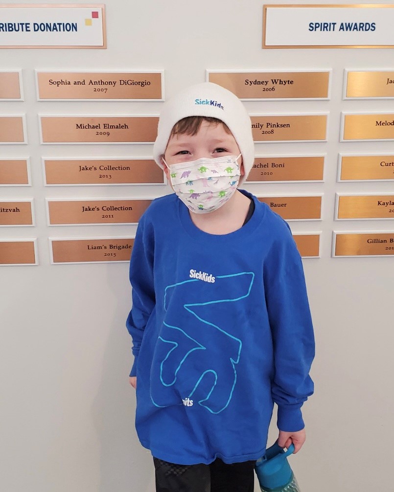 Liam in front of donor plaque wall