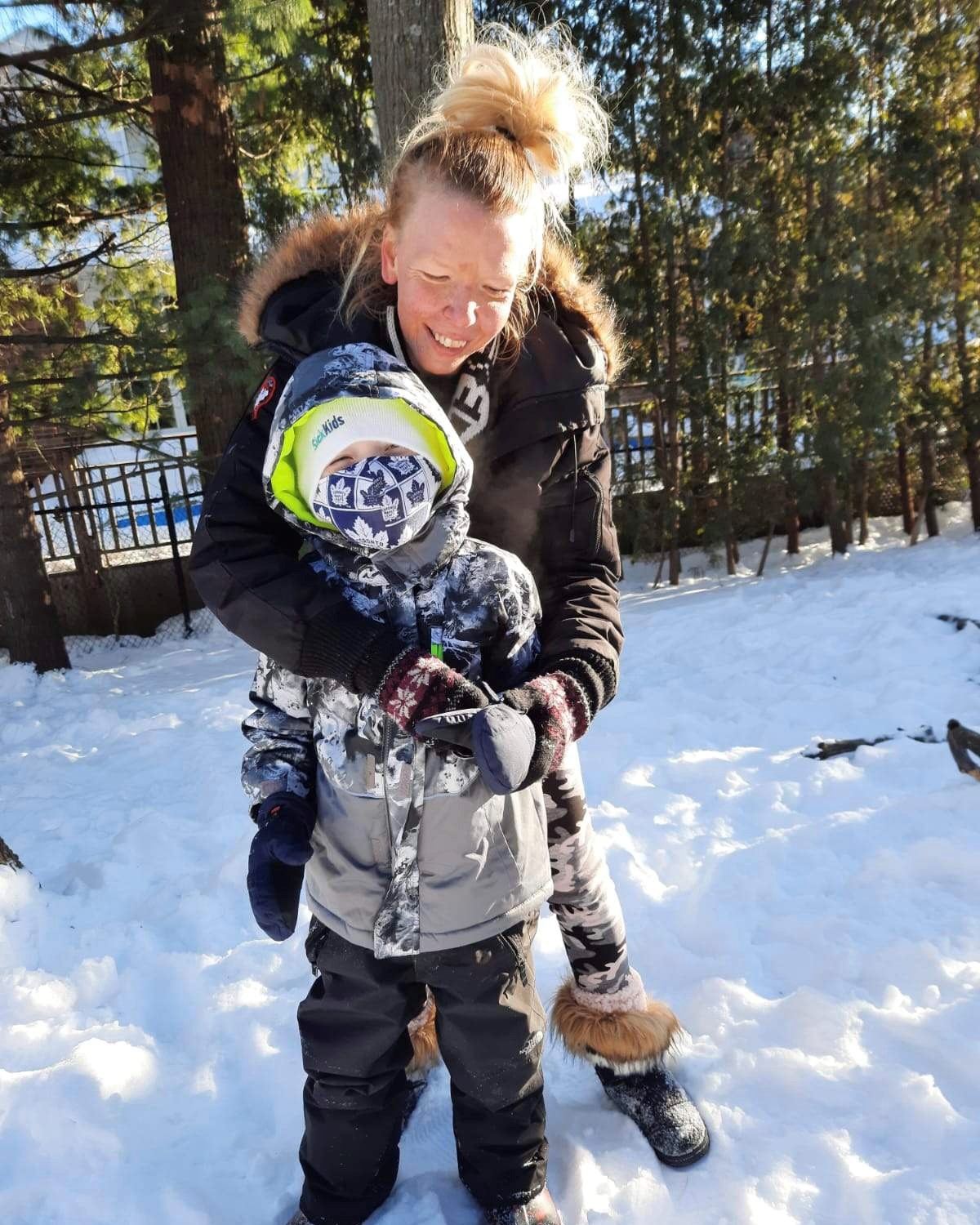 Liam enjoying the snow with his mom